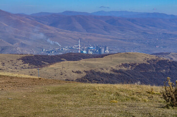 Obraz premium Hrazdan Thermal Power Plant scenic view from Tsaghkadzor Ski Resort on Mount Teghenis (Kotayk province, Armenia)