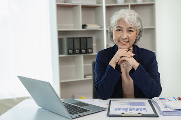 Senior Asian businesswoman analyzing new business Meet with partners online to discuss and plan new...