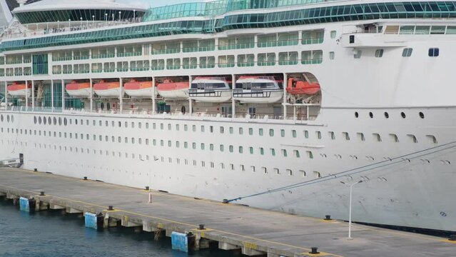 Lifeboats aboard travel ship docked at pier, equipment for relieve save in emergency situation which help avoid danger and provide safe boarding in rescue davits