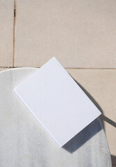 blank book for mockup design on marble table by the swimming pool