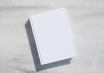 blank book for mockup design on marble table