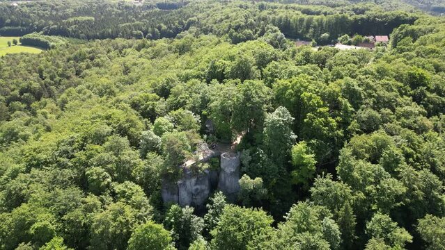 Orbit flight around ruins of Leienfels Castle and tree panorama near Pottenstein (Franconian Switzerland), Germany