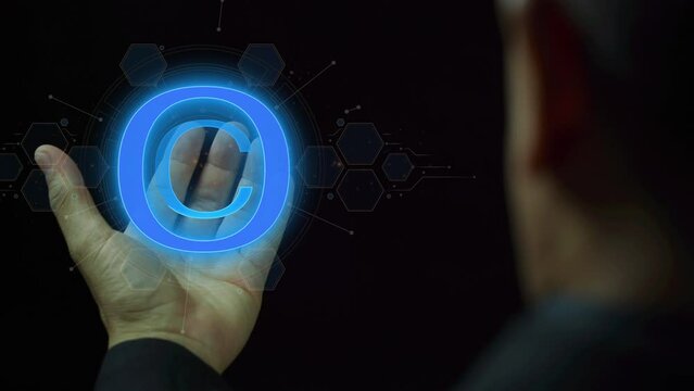 Copyright symbol for author rights and patented intellectual property. Copyleft trademark license. Copyright or patent concept. Businessman showing glowing neon line of copyright icon.