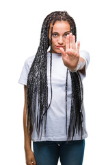 Young braided hair african american girl over isolated background doing stop sing with palm of the hand. Warning expression with negative and serious gesture on the face.