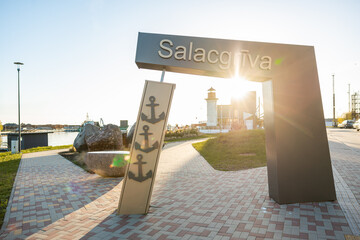 Welcoming entrance to Salacgriva in Latvia  with a decorative anchor sign and lighthouse in the...