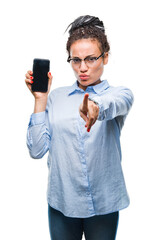 Young braided hair african american business girl showing screen of smartphone over isolated background pointing with finger to the camera and to you, hand sign, positive and confident gesture.