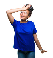 Young braided hair african american girl wearing glasses over isolated background surprised with...