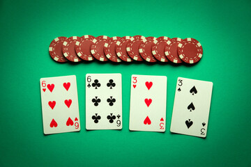 A very gambling game of poker with a winning combination of two pairs. Playing cards and chips on a...