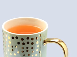 hot healthy lemon balm tea in a gilt mug