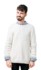 Young handsome man wearing winter sweater over isolated background winking looking at the camera...