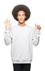 Young african american man with afro hair wearing sporty sweatshirt showing and pointing up with fingers number six while smiling confident and happy.