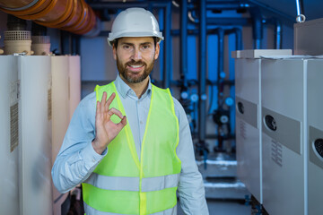 caucasian man wearing contractor uniform and safety helmet happy with big smile doing ok sign