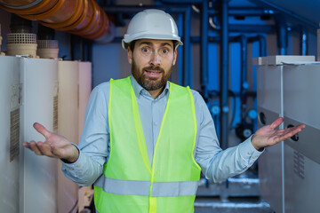 heating plant engineer man wearing uniform and security helmet have clueless and confused...