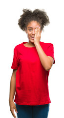 Young afro american woman over isolated background covering one eye with hand with confident smile...
