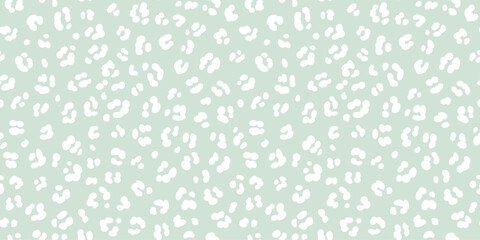 Pastel green leopard skin print seamless pattern. White cheetah spots on sage green background neutral safari print. © Olga