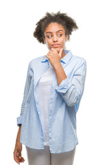 Young afro american woman over isolated background looking confident at the camera with smile with crossed arms and hand raised on chin. Thinking positive.