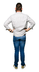 Fototapeta premium Young blond man wearing glasses standing backwards looking away with arms on body