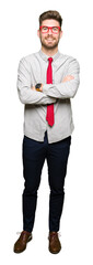 Young handsome business man wearing glasses happy face smiling with crossed arms looking at the camera. Positive person.