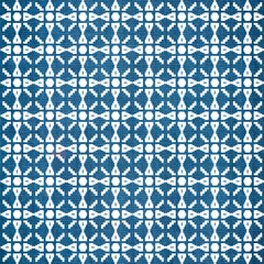 Seamless pattern with decorative thai flowers on indigo dyed fabric background.