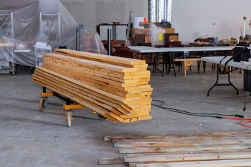 Stacked timber wooden boards on construction site are ready for use