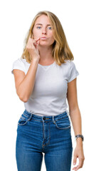 Beautiful young woman wearing casual white t-shirt over isolated background mouth and lips shut as...