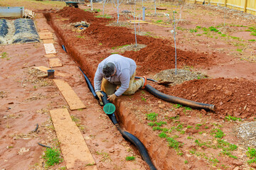 Installing storm drainage drain pipe into trench drain for draining rain water