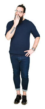 Young hipster man with long hair and beard wearing glasses bored yawning tired covering mouth with hand. Restless and sleepiness.