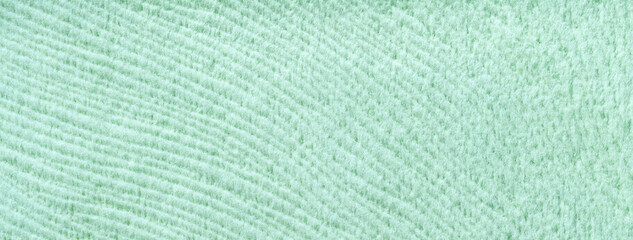 Texture of light pastel green woolen textile background from soft wool material, macro. Structure of cyan fabric