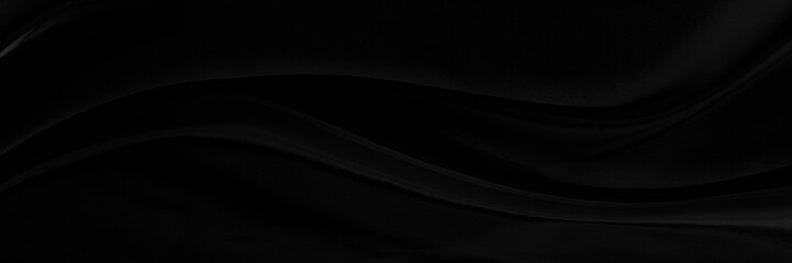 Black gray satin dark fabric texture luxurious shiny that is abstract silk cloth panorama background with patterns soft waves blur beautiful.