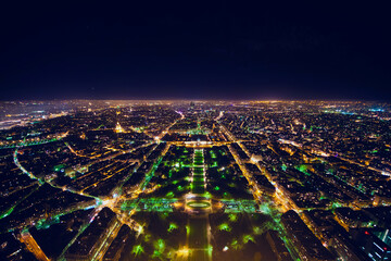 aerial view of illuminated night city panorama of Paris with street lights, drone top view from...
