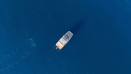 Yacht surrounded by swarm of Rhopilema nomadica Jellyfish, 
Drone view from mediterranean, israel,...