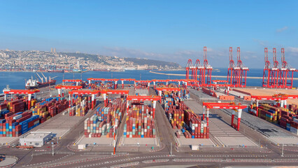 Rows of Shipping Containers on platform, Haifa, aerial

Drone view over cranes and cargo containers, Haifa,Israel,July,27,2022
