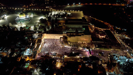 The western wall with thousnads of jewish prayers at night, aerial

Forgiveness Prayers at The Hebrew month of Elul, before yom kipur, drone view, September 2023
