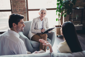 Fototapeta premium Photo of young couple argument positive conversation psychotherapist office professional psychologist marriage family problems solution