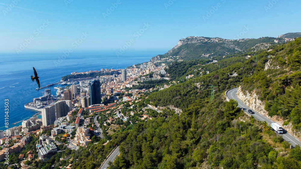 Wall mural view of rich city of Montecarlo, tall buildings, narrow streets famous for formula 1 race. mountain, sea and beautiful city on a sunny day vacation and tourism in rich city with yachts and luxury cars