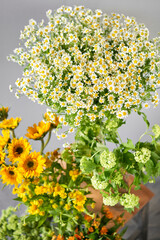 a bunch of yellow and white flowers are sitting on a table