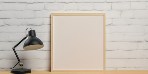 Workspace with Frame Mockup and Desk Lamp on Wooden Table. Empty Frame and Classic Lamp On Brick Wall Background. Generative AI