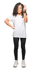 Fototapeta premium Young beautiful woman with curly hair wearing white t-shirt Doing Italian gesture with hand and fingers confident expression