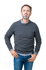 Fototapeta premium Handsome middle age senior man wearing a sweater over isolated background puffing cheeks with funny face. Mouth inflated with air, crazy expression.