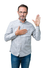 Handsome middle age elegant senior man wearing glasses over isolated background Swearing with hand...