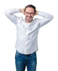 Handsome middle age elegant senior business man wearing glasses over isolated background Relaxing and stretching with arms and hands behind head and neck, smiling happy