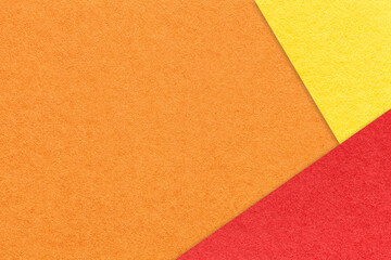 Fototapeta premium Texture of craft orange color paper background with red and yellow border. Vintage abstract ginger cardboard