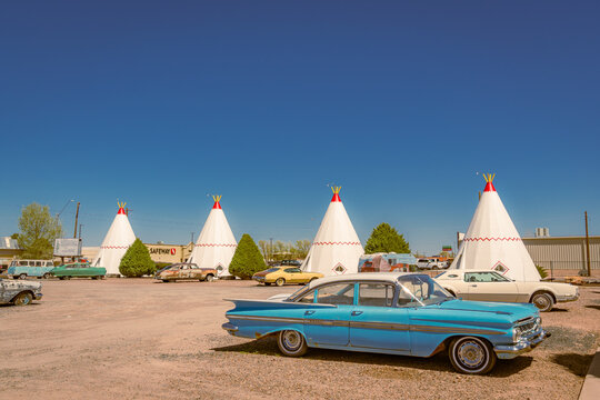Holbrook, AZ, US-April 13, 2024: Wigwam Motel, part of a motel chain built during the 1930s and 1940s on historic Route 66. The rooms are in teepees with classic cars in front.