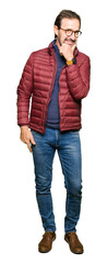 Fototapeta premium Middle age handsome man wearing glasses and winter coat looking confident at the camera with smile with crossed arms and hand raised on chin. Thinking positive.