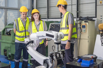 Trainees master robotics with hands-on workshops and quality control in manufacturing academy.