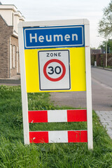 Place name sign for the village of Heumen (also speed limit of 30 km per hour)