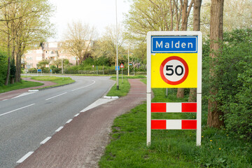 Place name sign for the village of Malden (also speed limit of 50 km per hour)