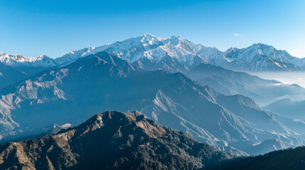 Obraz premium high-altitude drone photograph of snow-capped mountains under clear blue skies