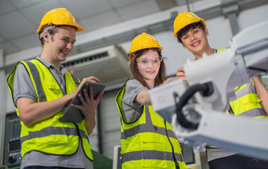 Trainees master robotics with hands-on workshops and quality control in manufacturing academy.