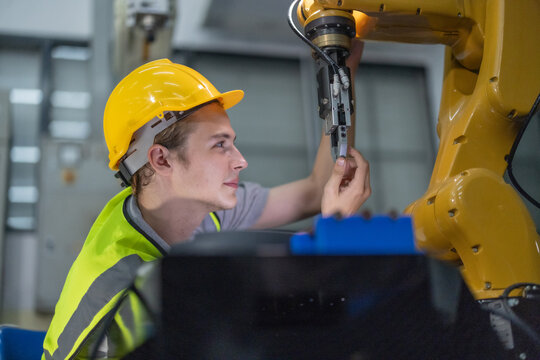 Trainees master robotics with hands-on workshops and quality control in manufacturing academy.